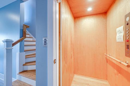 a staircase in a house with blue walls at Gorgeous Kure Beach Townhome - Walk to Ocean! in Kure Beach