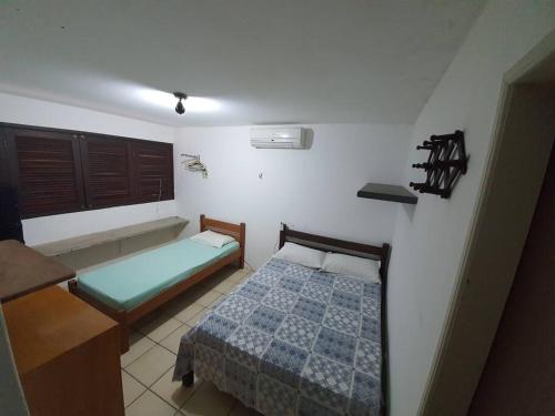 a bedroom with a bed and a tub in it at Casa com Piscina em Itamaracá in Itamaracá