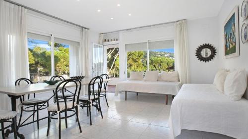 a bedroom with a table and chairs and a dining room at 1Pand02 in Llafranc