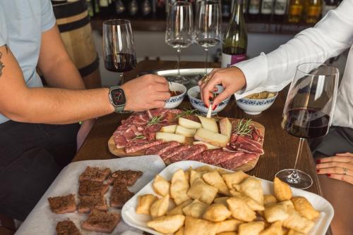 a group of people standing around a table with food at Vivi Luxury Country House in Comano