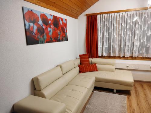 a living room with a couch and a window at Klein aber fein in Escholzmatt
