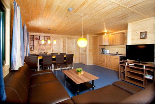 a living room with a couch and a table at Ferienhaus 8 Personen - b46443 