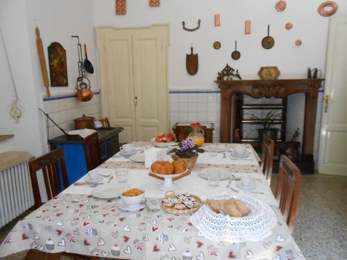 a table with a table cloth with food on it at B&B La Quiete in Albavilla
