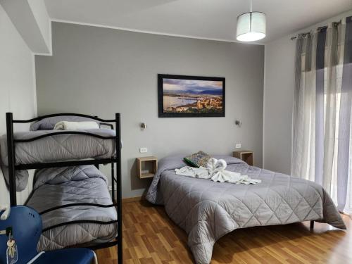 a bedroom with a bed and a bunk bed at Milazzo La Porta Delle Eolie 2.0 in Milazzo
