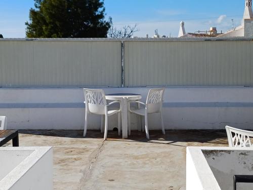 a table and two chairs on a patio at Guest House Casa Ramos on the Strip in Albufeira