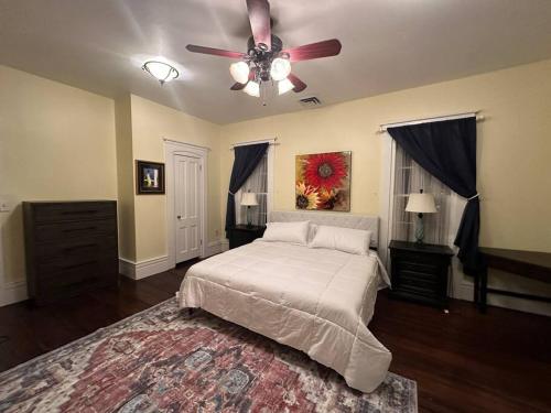 sypialnia z łóżkiem i wentylatorem sufitowym w obiekcie Luxurious Historic Victorian w mieście Warren