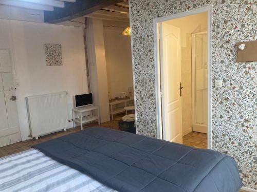 Una cama o camas en una habitación de L'Intemporelle