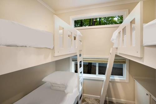 a room with two bunk beds and a window at HTR Door County in Egg Harbor