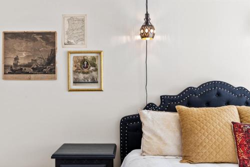 a bedroom with a bed with a lamp and a table at Bombastic Home - Steps to Beach - GameRm - Hot Tub - Pet Friendly in Surf City