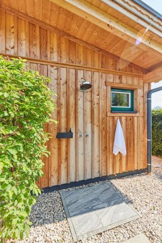 a wooden shed with a door and a window at DAS SALZBERG Hideaway Bad Aussee - Adults only in Bad Aussee