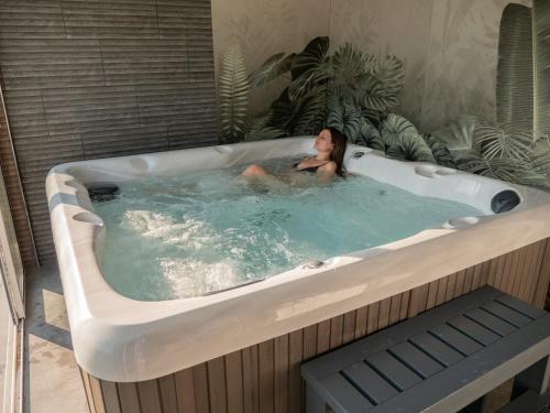 a woman is in a jacuzzi tub at Mountain Sky View - Маунтин Скай Вю in Gabrovo