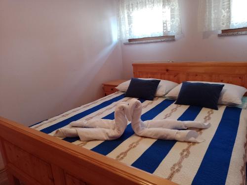 a bedroom with two towels on a bed at Apartman Centar Fužine in Fužine