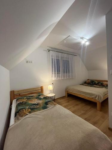 a bedroom with two beds in a attic at Domki na Groniku in Nowy Targ
