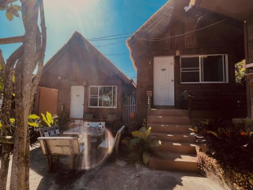 a house with two white doors and a porch at Shin Sane Guest House in Mae Salong