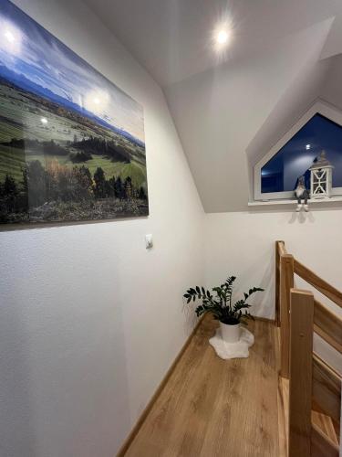 a room with a staircase with a painting on the wall at Domki na Groniku in Nowy Targ