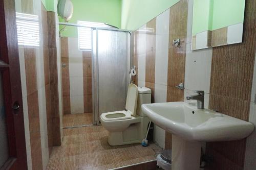 a bathroom with a toilet and a sink at Suisse View Residence Kandy in Kandy