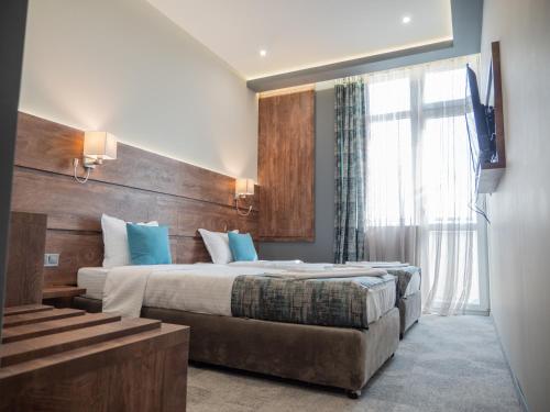 a hotel room with a bed and a television at Mountain Sky View - Маунтин Скай Вю in Gabrovo