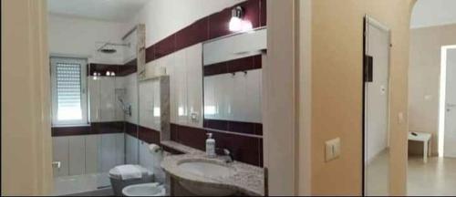 a bathroom with a sink and a toilet and a tub at Apartment Marina di Ascea 2 in Castellammare di Velia