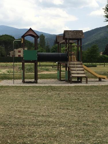 a park with a playground with a slide at Maison de village in Malaucène