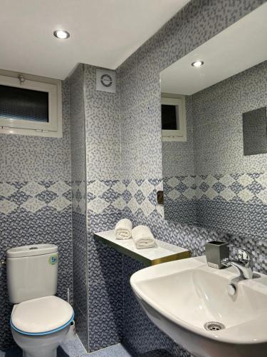 a bathroom with a toilet and a sink at Appartement de luxe Marrakech Menara in Marrakesh