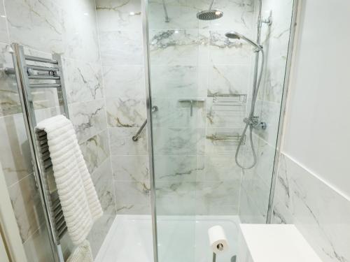 a bathroom with a shower and a sink at The Barn in Snitterby