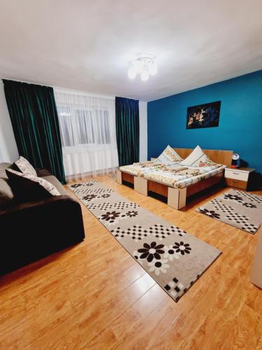 a living room with a bed and a couch at Pensiunea Adriana in Vadu Izei