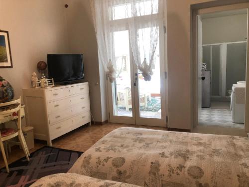 a bedroom with a bed and a television on a dresser at B & B Da Giusy in Corte Franca