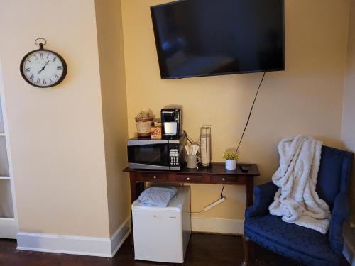 a room with a table and a microwave and a chair at The Brower House in Saint Cloud