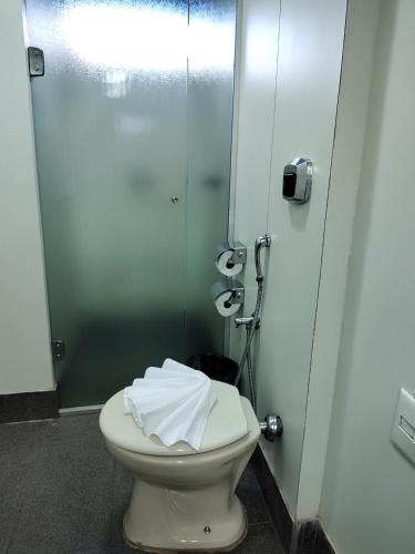 a bathroom with a toilet in a stall at Hotel Oscar Gold Savassi in Belo Horizonte