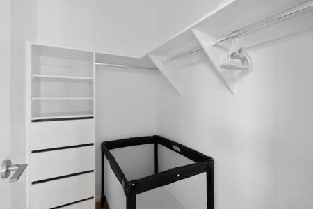 a white room with a black shelf and lights at Brandnew 4BR modern family home Park Ridge in Park Ridge