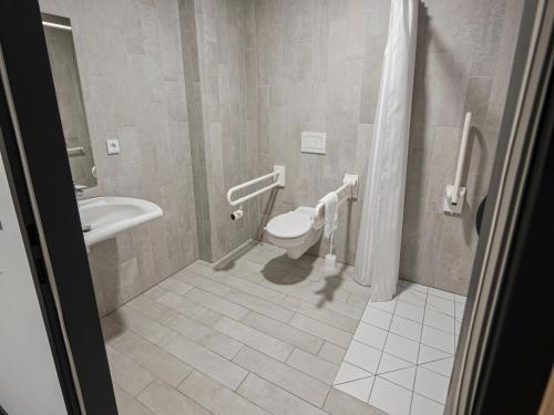uma casa de banho com um WC e um lavatório em B&B HOTEL Wiener Neudorf em Wiener Neudorf