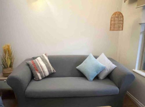 a couch with pillows on it in a living room at Belluca Villa, Middleton Beach in Albany