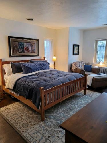 a bedroom with a large bed and a living room at The Brower House in Saint Cloud