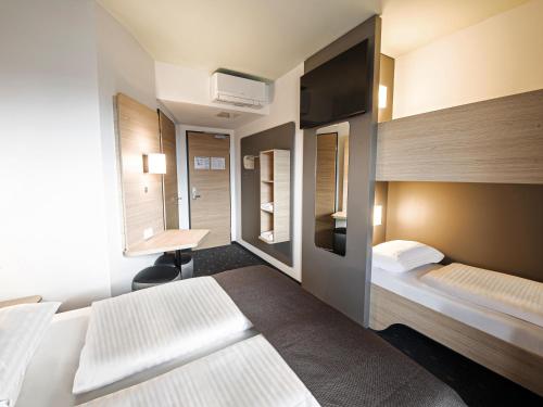 Postel nebo postele na pokoji v ubytování B&B HOTEL Wiener Neudorf