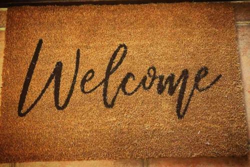 a welcome mat with the word welcome written on it at Belluca Villa, Middleton Beach in Albany