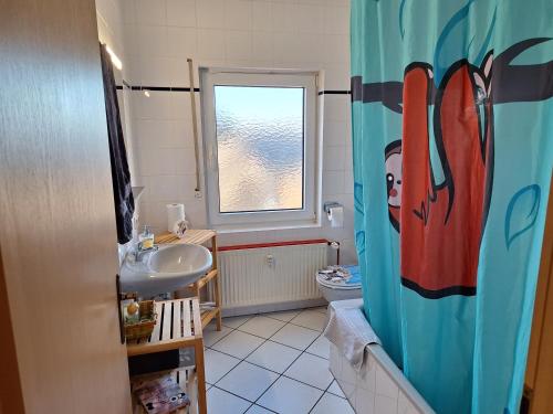 a bathroom with a sink and a toilet at Ferienwohnung Lua in Rorodt