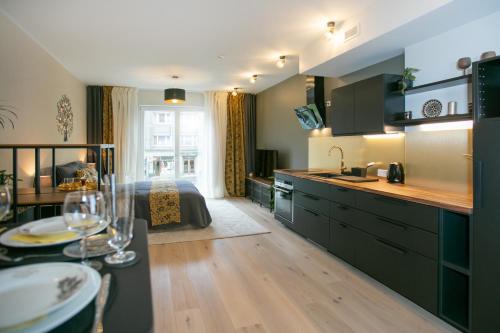 a kitchen and living room with a bed and a table at Das Appartement Tallinn in Tallinn