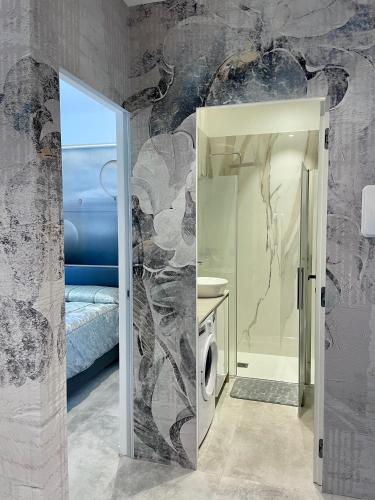 a bathroom with a shower and a sink and a toilet at Rondinella Suite in Lignano Sabbiadoro