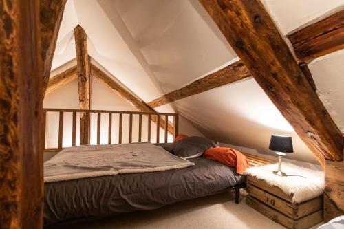 a bedroom with a bed in a attic at Les Montagnettes in Les Orres