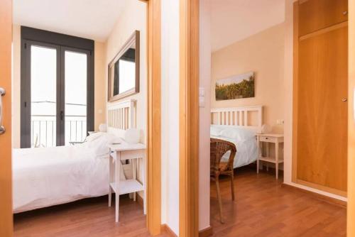 a bedroom with a bed and a table with a desk at Modern 2 Bed Apartment in Historic Centre in Mutxamel