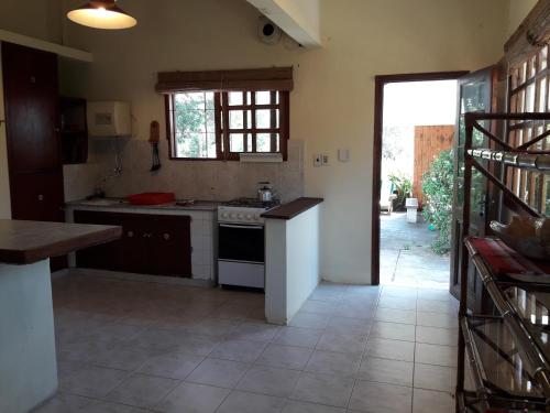 a kitchen with a sink and a stove top oven at Chalet La Floresta in La Floresta