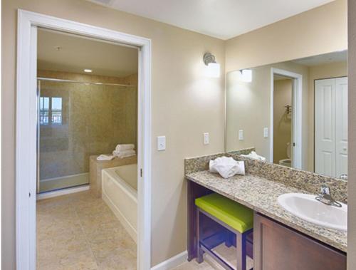 a bathroom with a sink and a tub at Holiday Homes 2 Rooms 4 Beds 2 Bathrooms 8 Occupants in Orlando