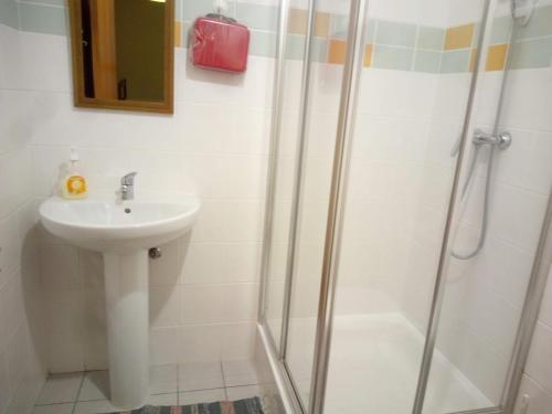 a bathroom with a sink and a shower at Costa Lodge, private room in Santa Cruz