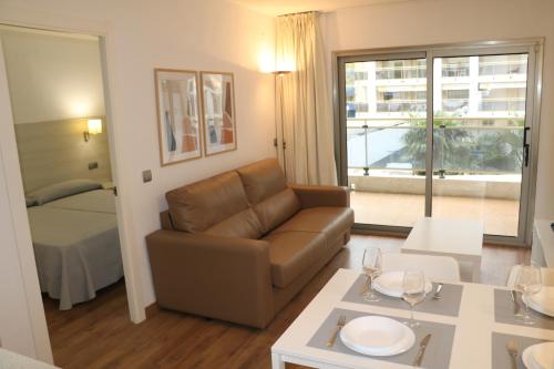 a living room with a couch and a table at MyF Michelangelo sun in Salou