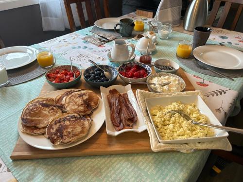 a table full of breakfast food on a table at Berkie’s Bed & Breakfast in Port Alberni
