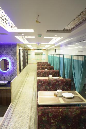 a row of chairs in a room with blue curtains at Hotel City View in Navi Mumbai