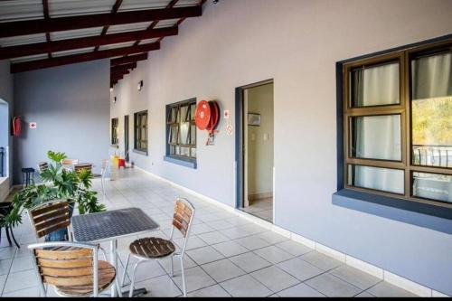 un couloir avec une table et des chaises dans un bâtiment dans l'établissement Honeymoon suite in Schoemansville, à Hartbeespoort