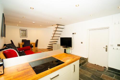 a kitchen and living room with a red couch at Modern 1-Bed House in Bristol for 4 people in Bristol