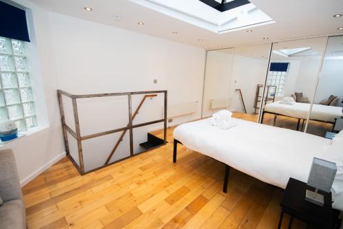 a room with two beds and a mirror at Modern 1-Bed House in Bristol for 4 people in Bristol