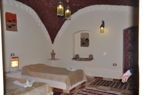 a bedroom with two beds in a room at Oasis Panorama Hotel in Bawiti